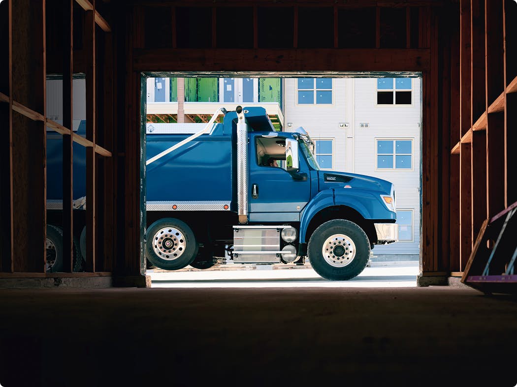 A blue truck in front of a building