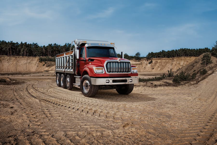A red truck on a dirt road