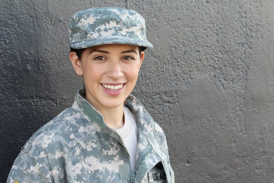 A person in military uniform smiling